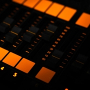 a close up of a sound board with orange lights