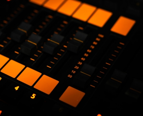 a close up of a sound board with orange lights