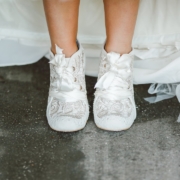 a close up of a person wearing white shoes