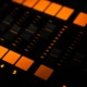 a close up of a sound board with orange lights