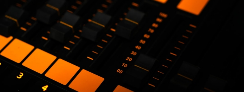 a close up of a sound board with orange lights