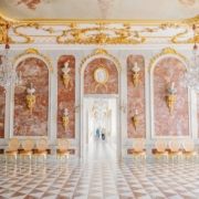 A large room with a checkered floor and a chandelier