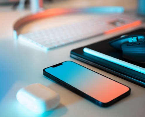 a mouse, keyboard, and cell phone sitting on a desk