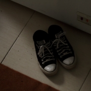 a pair of black and white tennis shoes on the floor