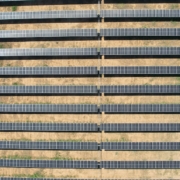 a row of rows of solar panels in a field