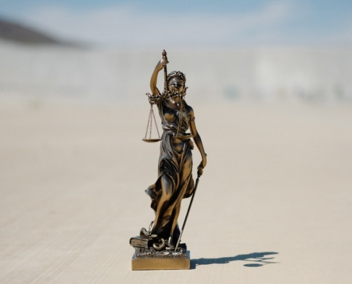 a statue of a lady justice holding a scale