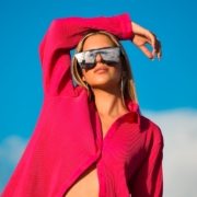 a woman wearing a red hoodie and sunglasses