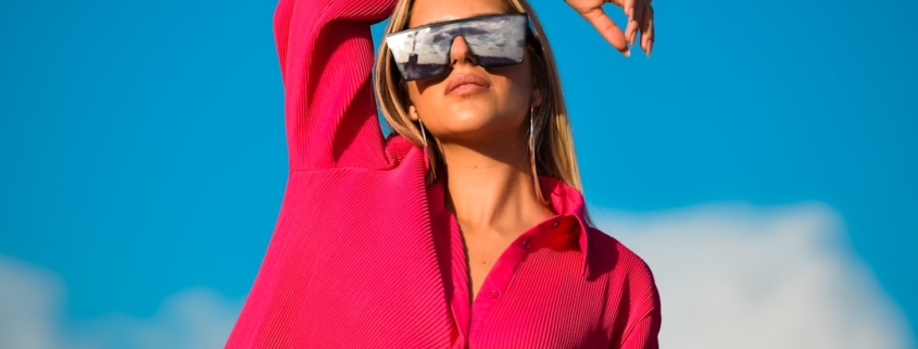a woman wearing a red hoodie and sunglasses