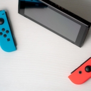 blue nintendo switch beside black tablet computer