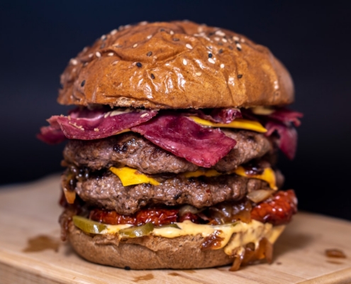 closeup photo of burger on brown surface