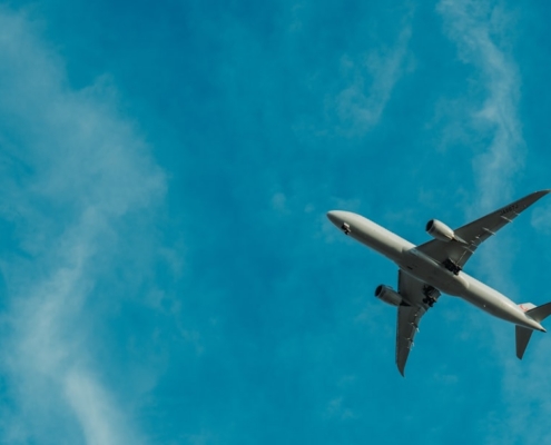 gray airplane flying during daytime