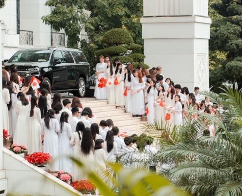 Group of women in white dresses walking down stairs