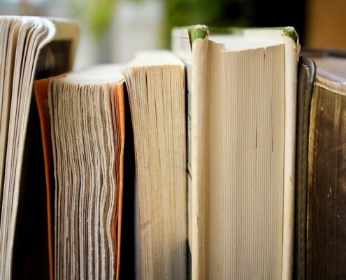 macro photo of five assorted books