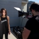 man filming standing woman