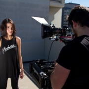 man filming standing woman
