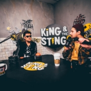 man in black and yellow jacket holding black microphone