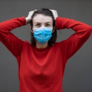 man in red sweater with face mask