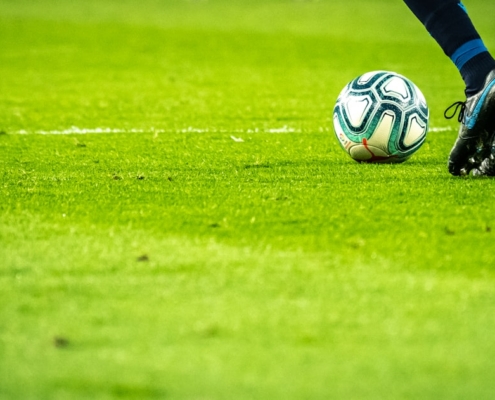 man playing soccer game on field