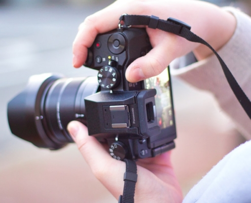 person holding black dslr camera