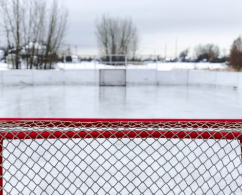 red and white goal net on ice field