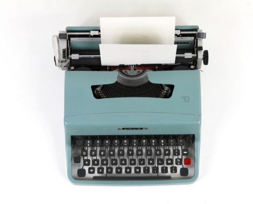 teal and black typewriter machine