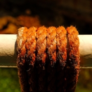 Thick, weathered rope wrapped around a pole.