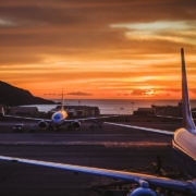 three airplane parked on road during golden hour