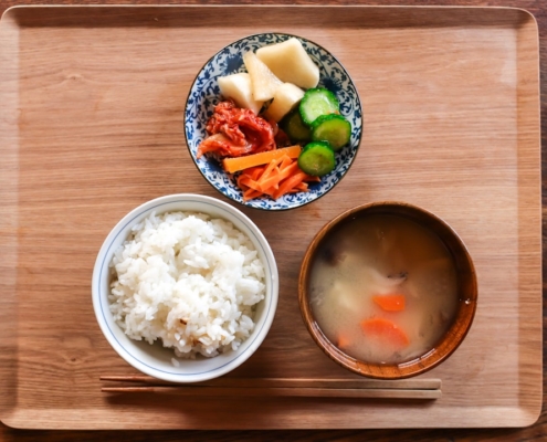 three kinds of foods on bowls on top of brown serving tray
