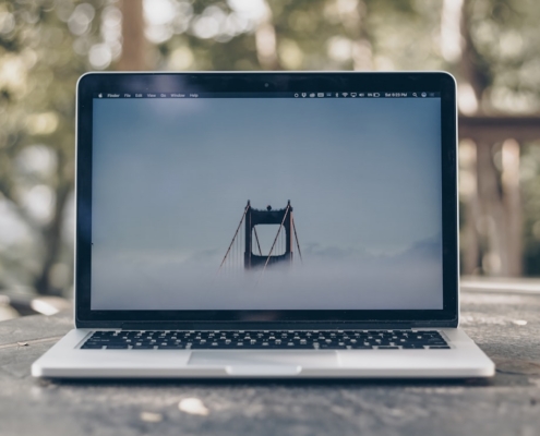 turned on MacBook Pro on gray surface