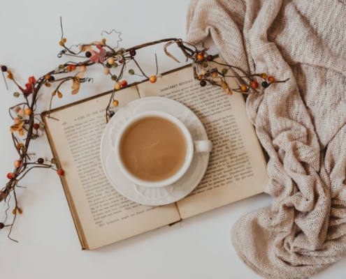 white ceramic mug on white book