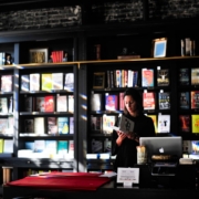 woman standing in front of book shelf