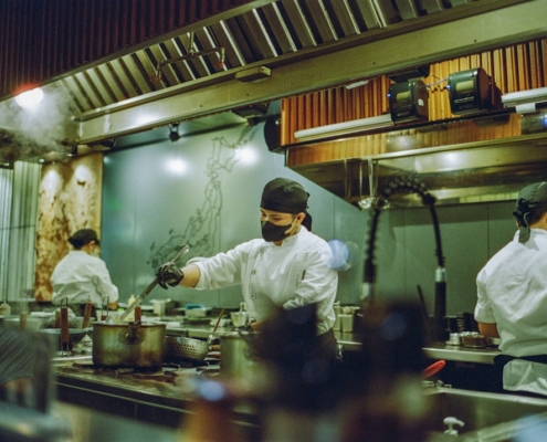 A group of chefs preparing food in a kitchen