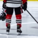a hockey player with a helmet and hockey stick