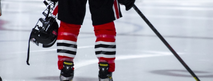 a hockey player with a helmet and hockey stick