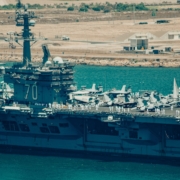 a large navy ship in a body of water