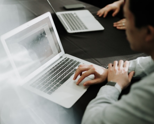 a man sitting in front of a laptop computer