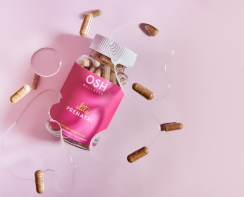 A pink box of pills and a glass of water