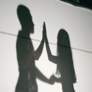 A shadow of two people holding hands