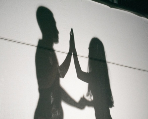 A shadow of two people holding hands