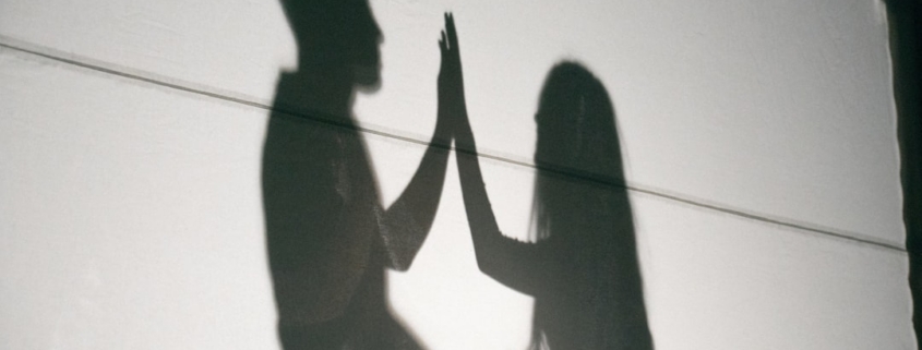 A shadow of two people holding hands