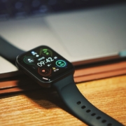 a smart watch sitting on top of a wooden table