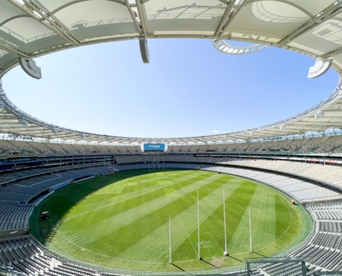 a sports stadium with a green field