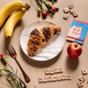 banana fruit and bread on white ceramic plate
