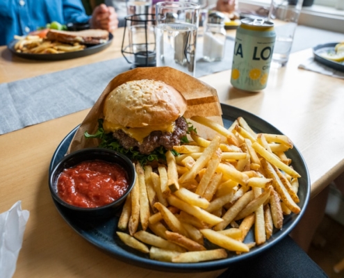 burger and fries on black plate