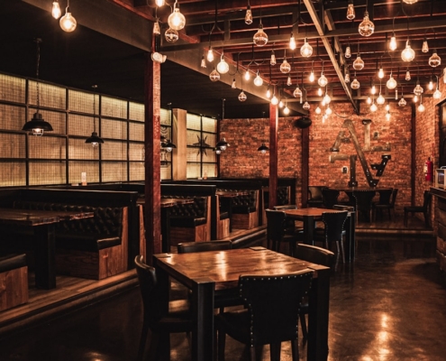 Cozy restaurant interior with warm lighting and exposed brick.