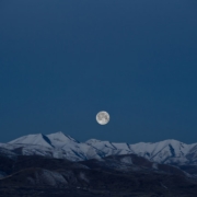 full-moon above snow-capped mountain painting