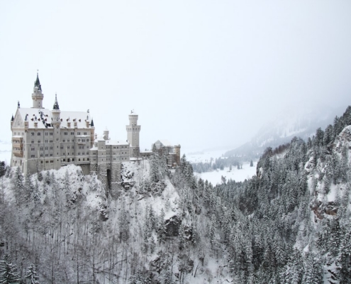 gray concrete building on mountain covered with snow