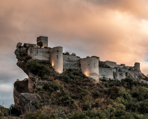 gray concrete castle under cloudy sky during daytime