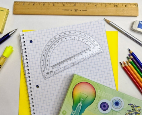 green and yellow scissors on white graphing paper