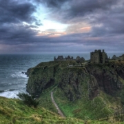 landscape photo of castle on top of mountain peak